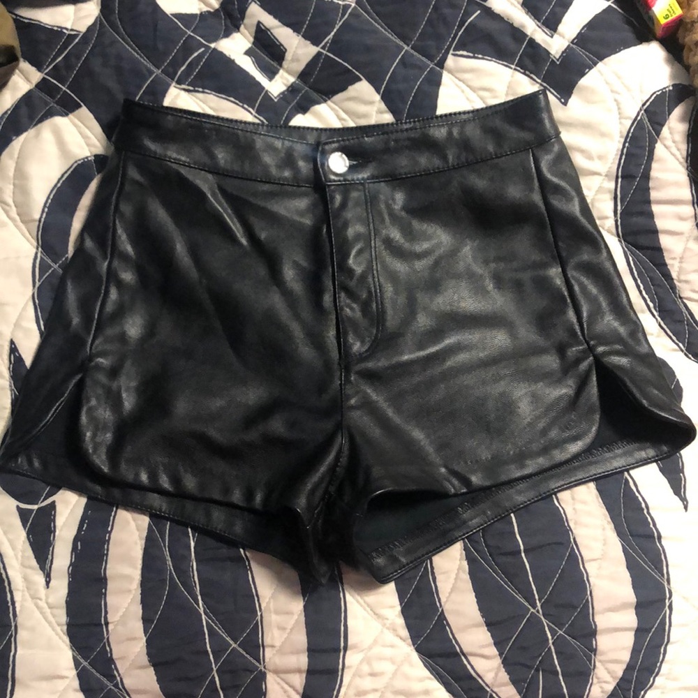 Black faux leather booty shorts.